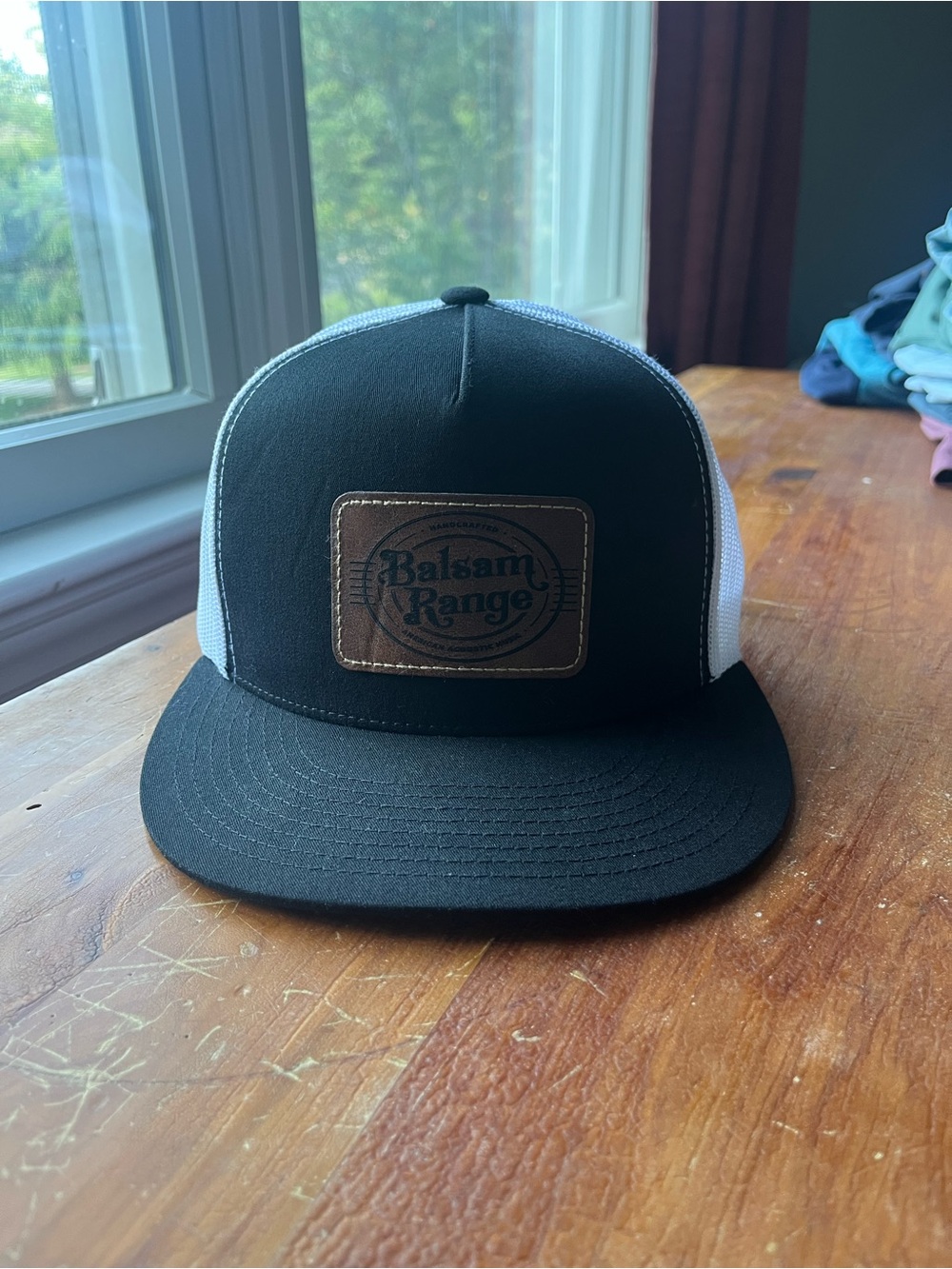 The Classic Black and White Trucker Hat with Brown Patch